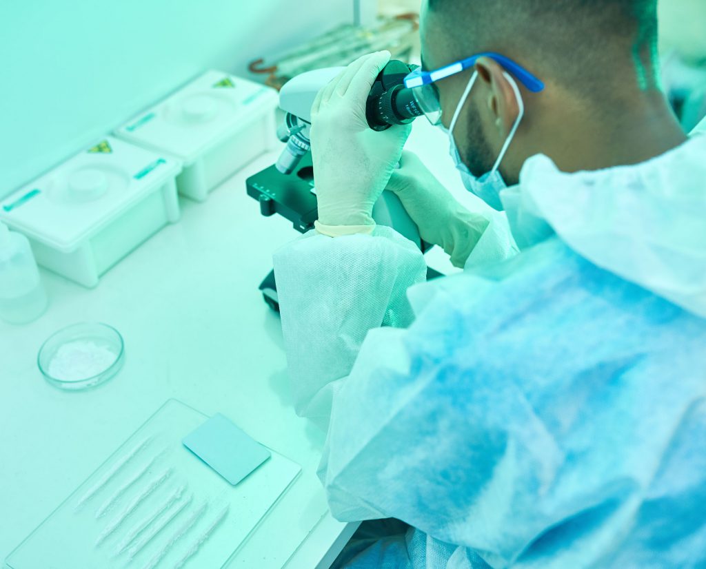 Scientist using microscope in a lab